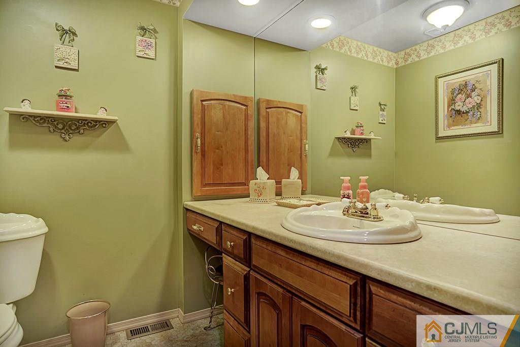 10 Overbrook Road Somerset, NJ 08873 - Photo 13 of 26 a bathroom with a sink mirror vanity and toilet