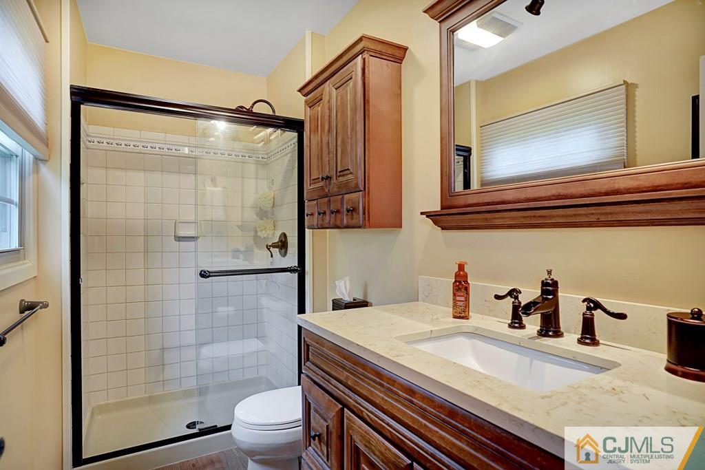 10 Overbrook Road Somerset, NJ 08873 - Photo 16 of 26 a bathroom with a sink a toilet and shower