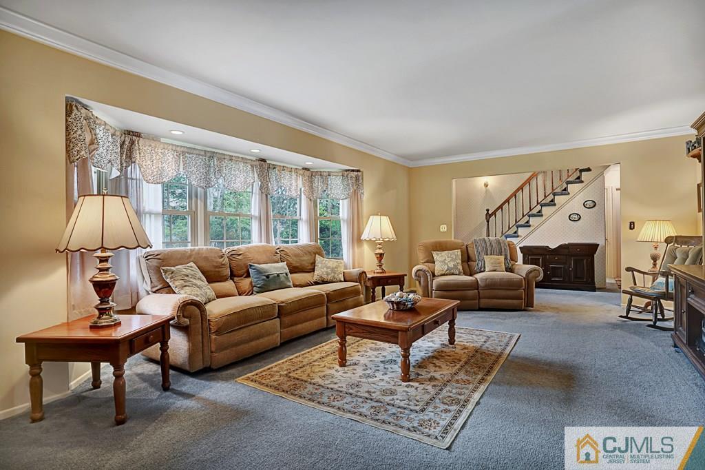10 Overbrook Road Somerset, NJ 08873 - Photo 5 of 26 a living room with furniture a lamp a rug and a large window