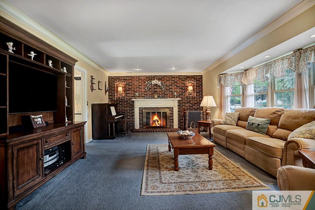 10 Overbrook Road Somerset, NJ 08873 - Photo 6 of 26 a living room with furniture a flat screen tv and a fireplace