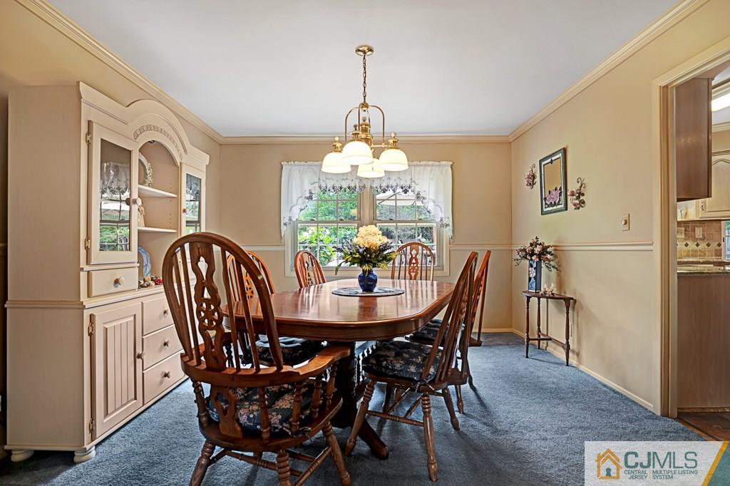 10 Overbrook Road Somerset, NJ 08873 - Photo 7 of 26 a dining room with furniture a chandelier and wooden floor