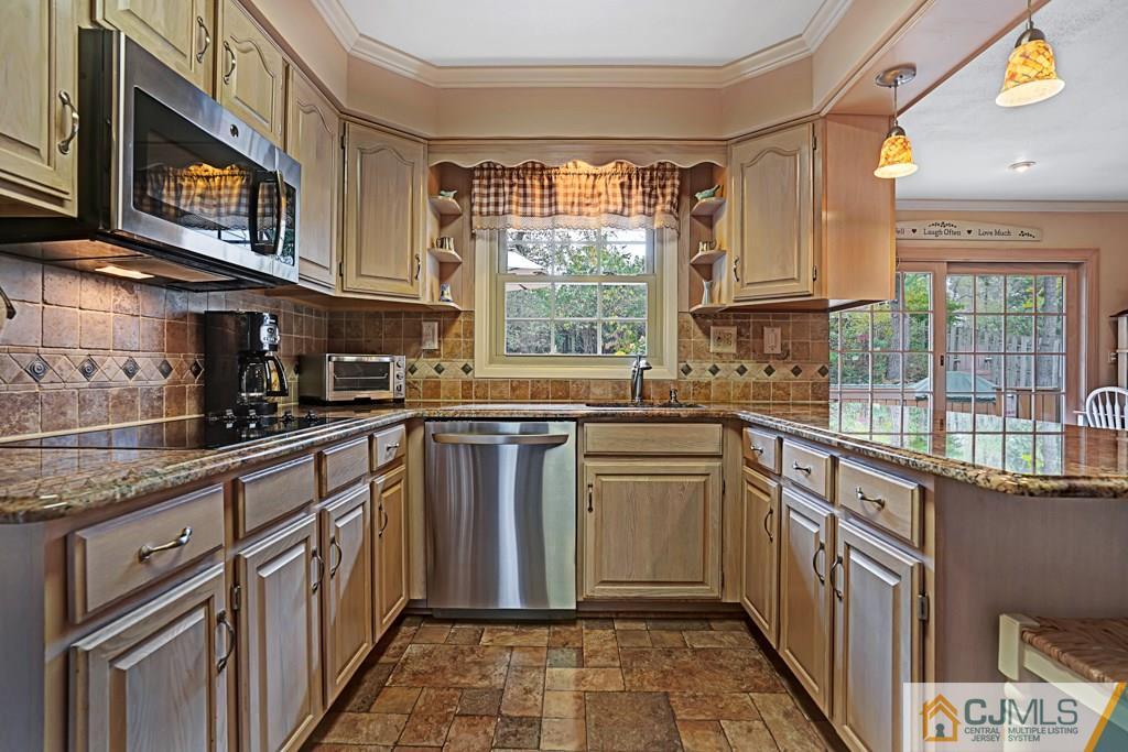 10 Overbrook Road Somerset, NJ 08873 - Photo 9 of 26 a kitchen with stainless steel appliances granite countertop a stove a sink and a microwave