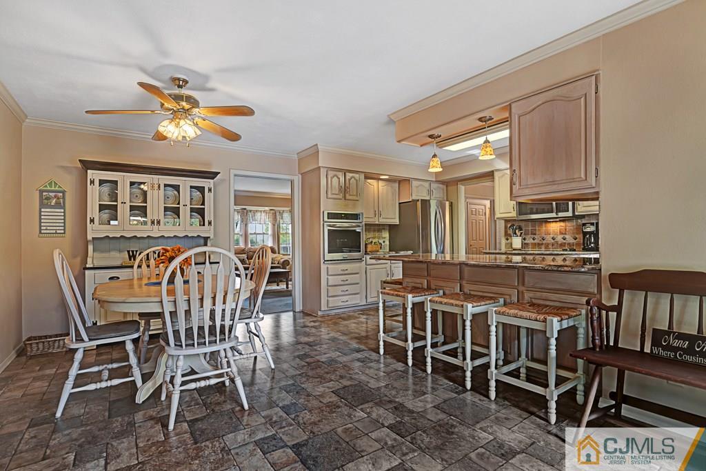 10 Overbrook Road Somerset, NJ 08873 - Photo 10 of 26 a dining room with furniture a rug and wooden floor