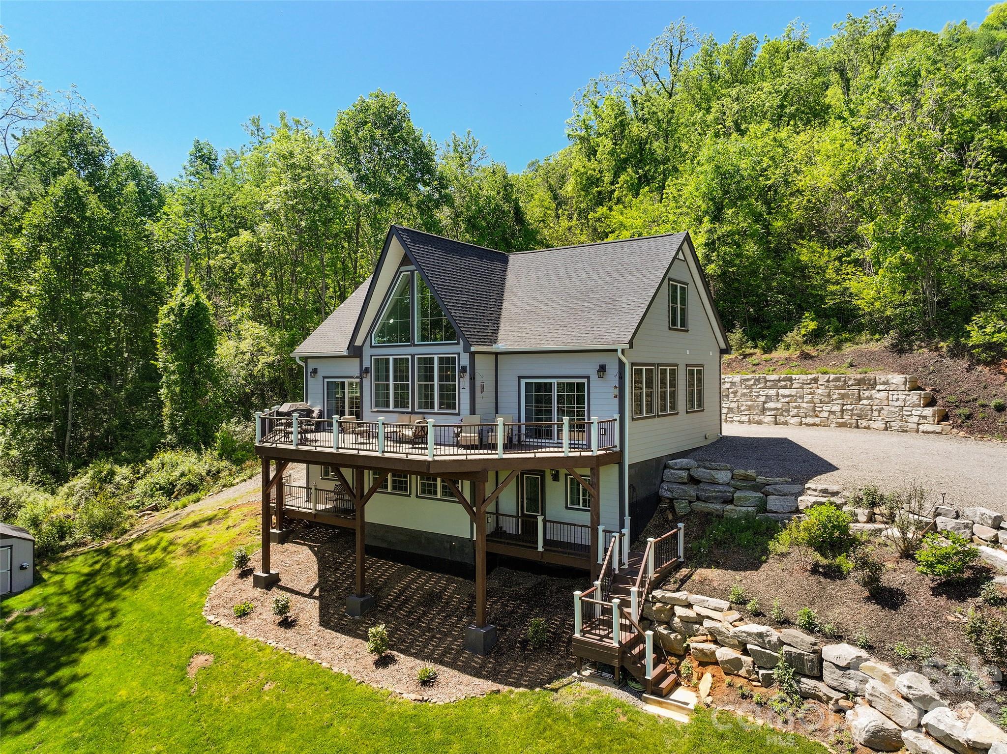 114 Nesting Ridge Waynesville, NC 28785 - Photo 1 of 40 a view of house with yard entertaining space and sitting area