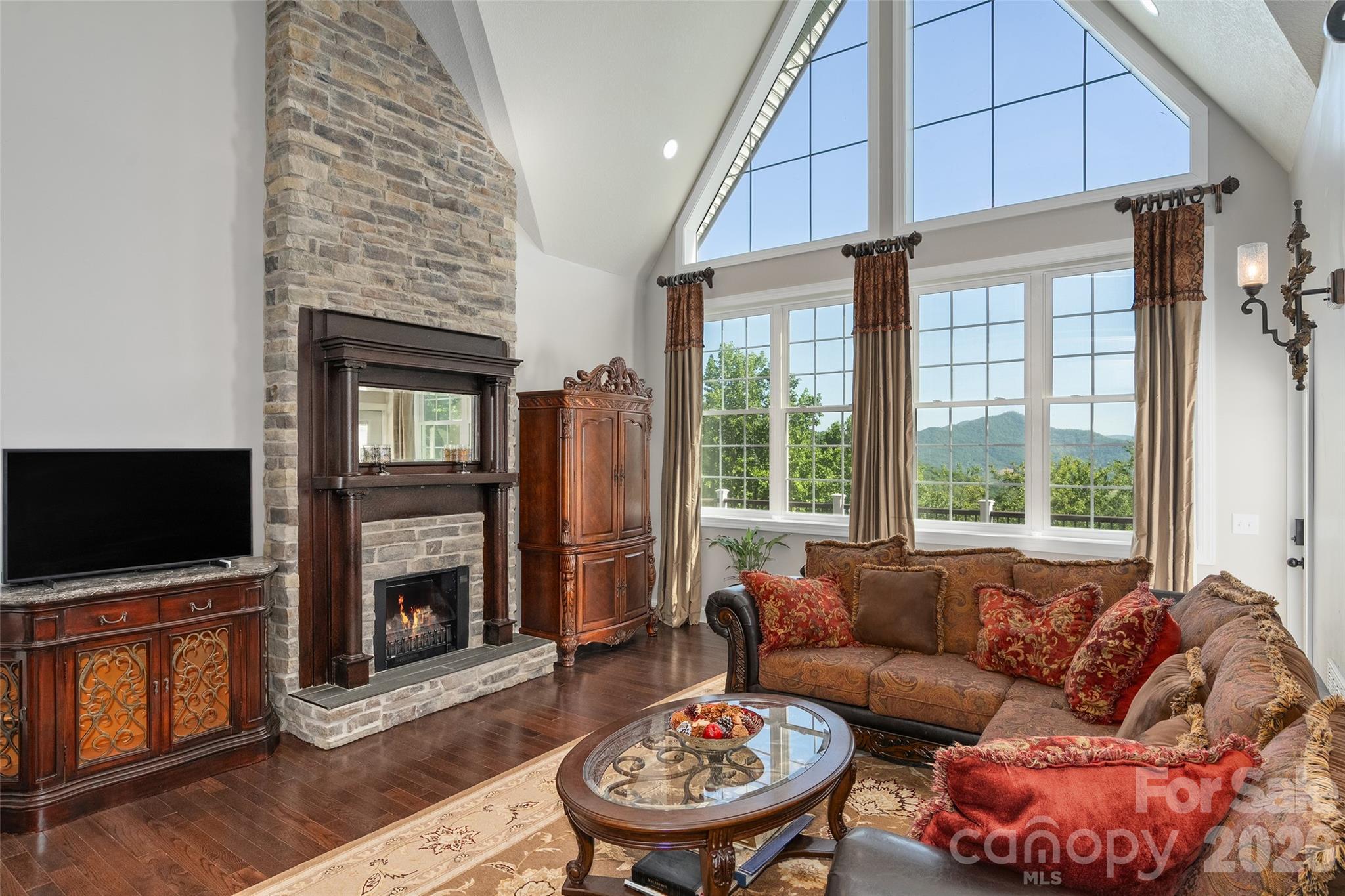 114 Nesting Ridge Waynesville, NC 28785 - Photo 14 of 40 a living room with furniture a flat screen tv and a fireplace