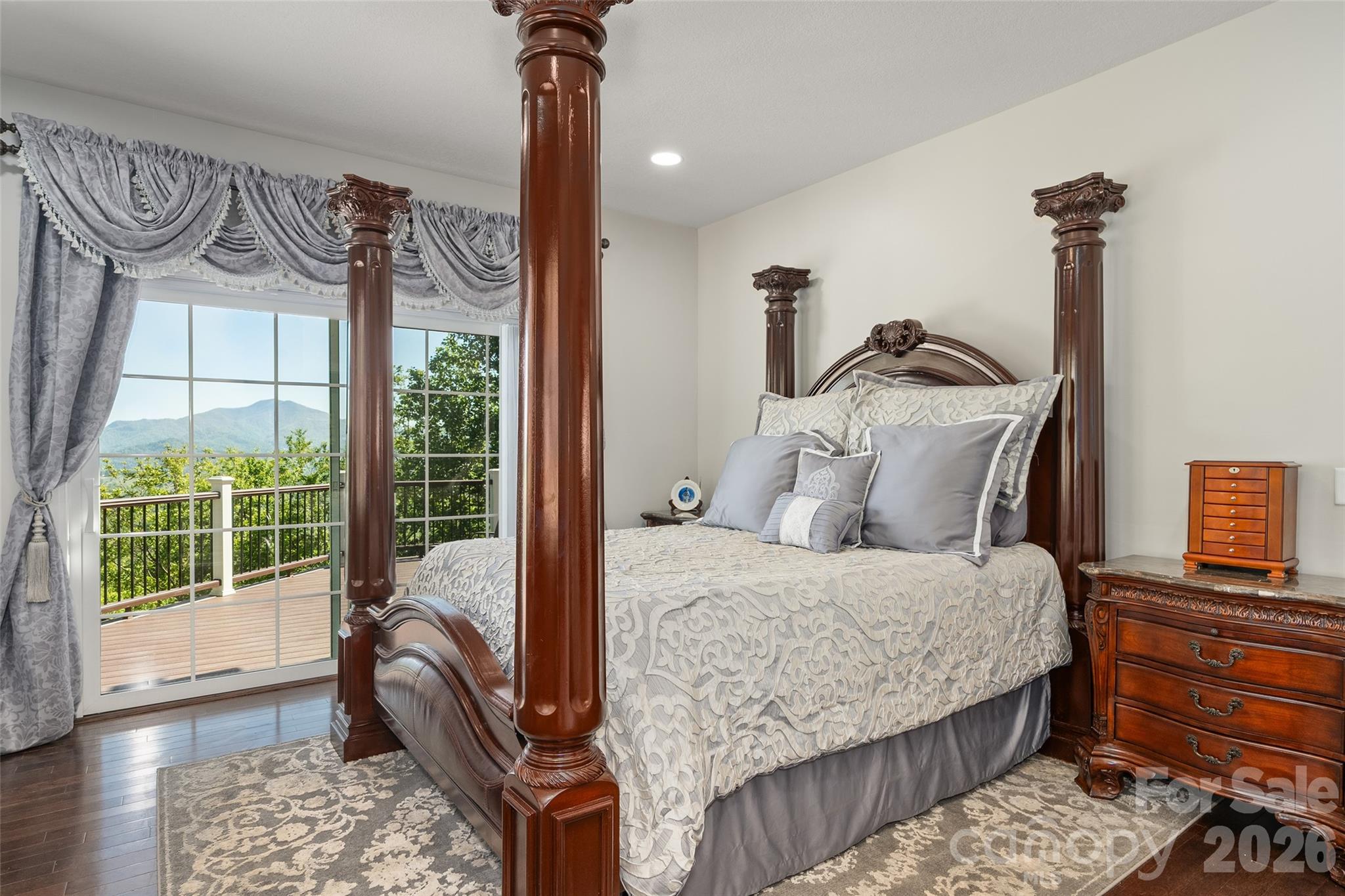 114 Nesting Ridge Waynesville, NC 28785 - Photo 18 of 40 a bedroom with a bed and wooden floor
