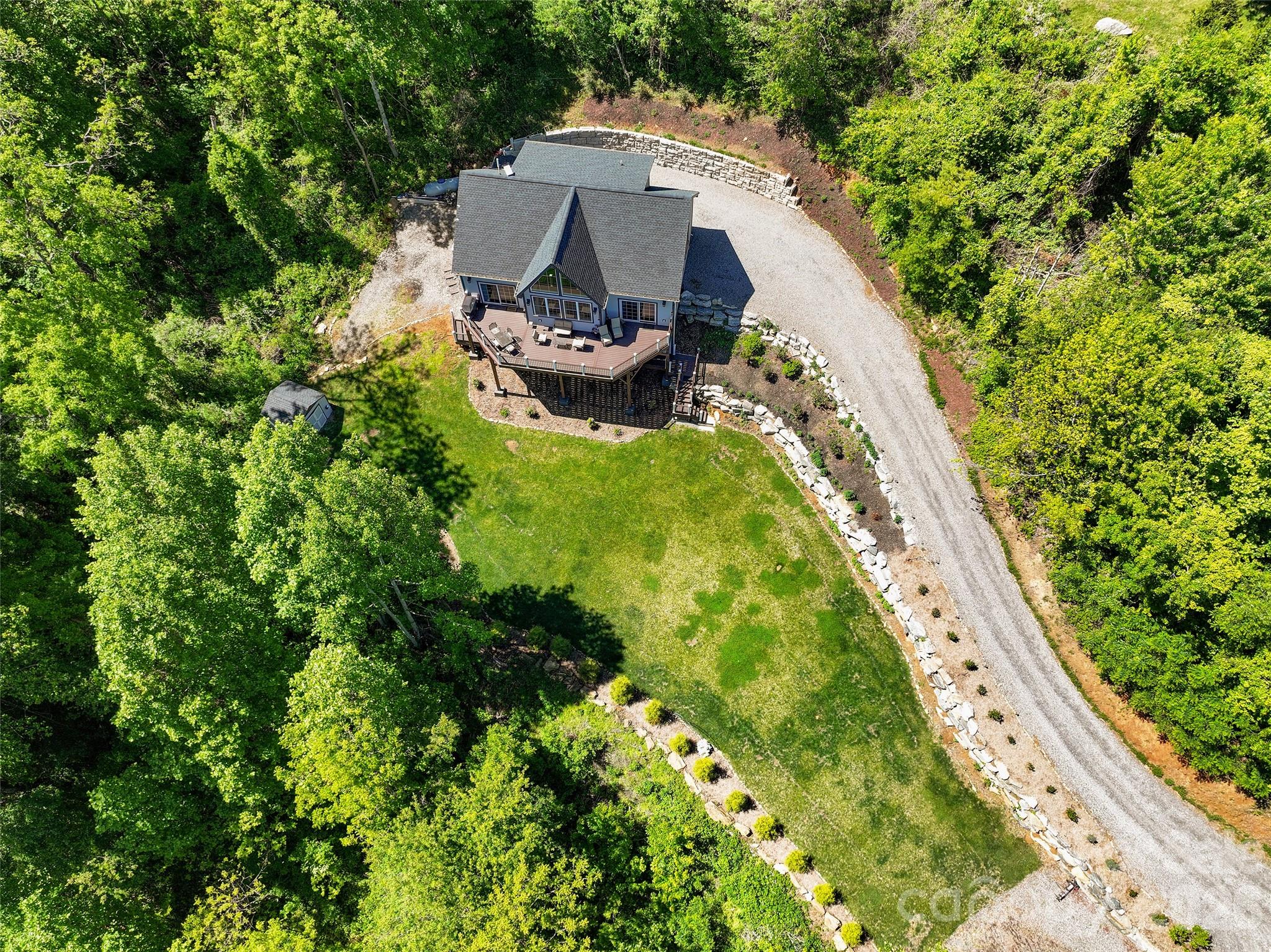 114 Nesting Ridge Waynesville, NC 28785 - Photo 4 of 40 a aerial view of a house with garden space and sitting area