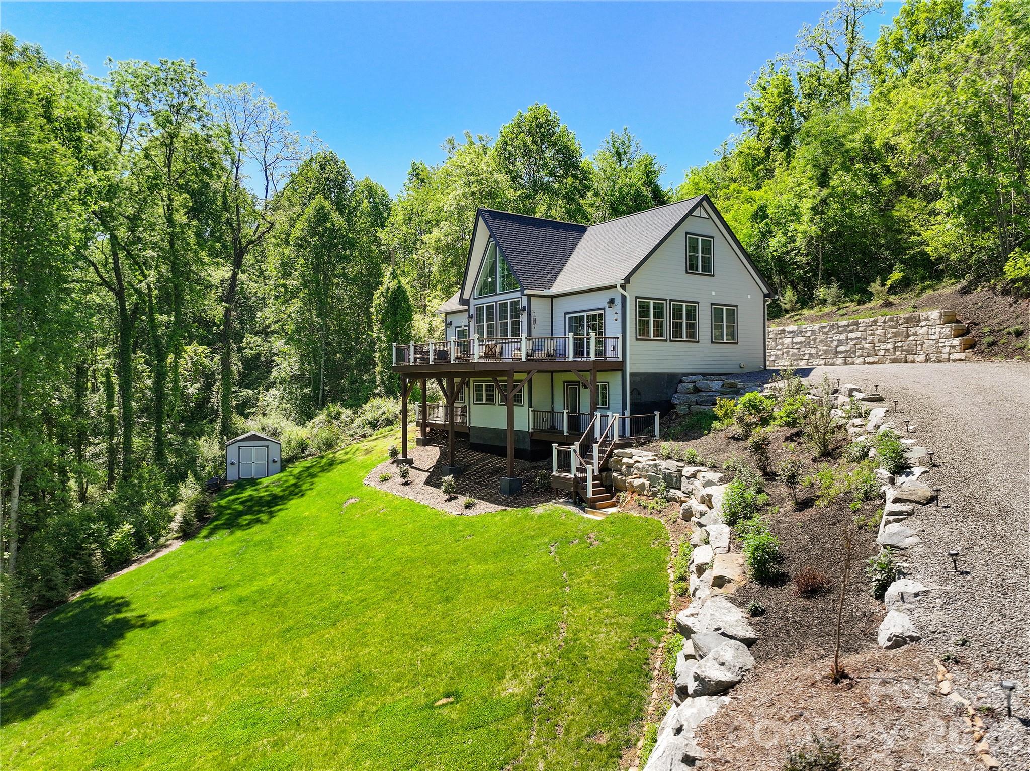 114 Nesting Ridge Waynesville, NC 28785 - Photo 5 of 40 a view of a house with a yard patio and a garden