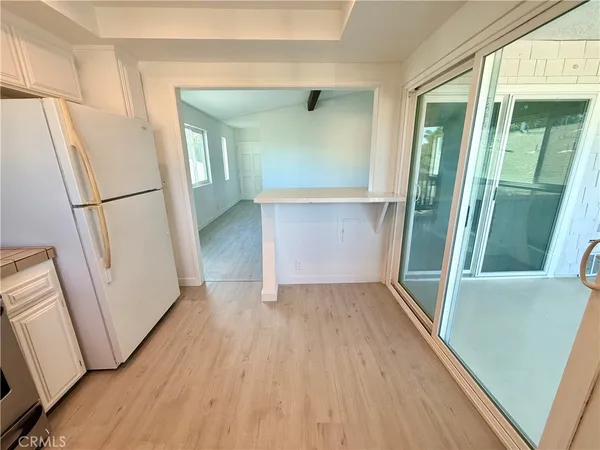 an entryway with wooden floor and door