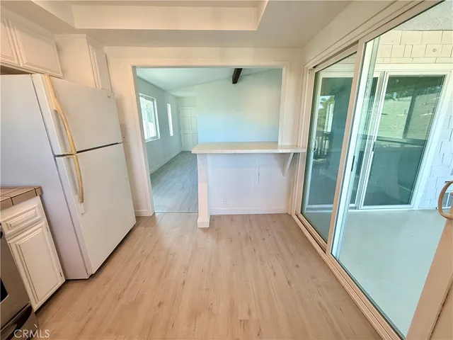 an entryway with wooden floor and door