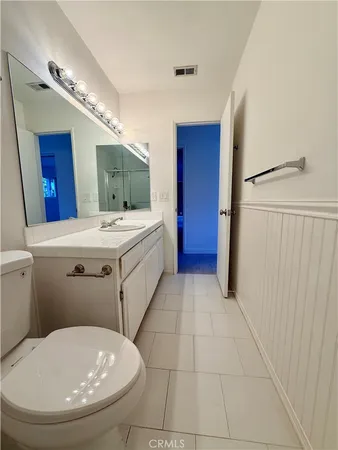 a bathroom with a sink a toilet and mirror