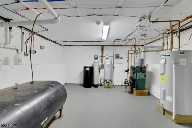 a view of a white house with a sink and a yard