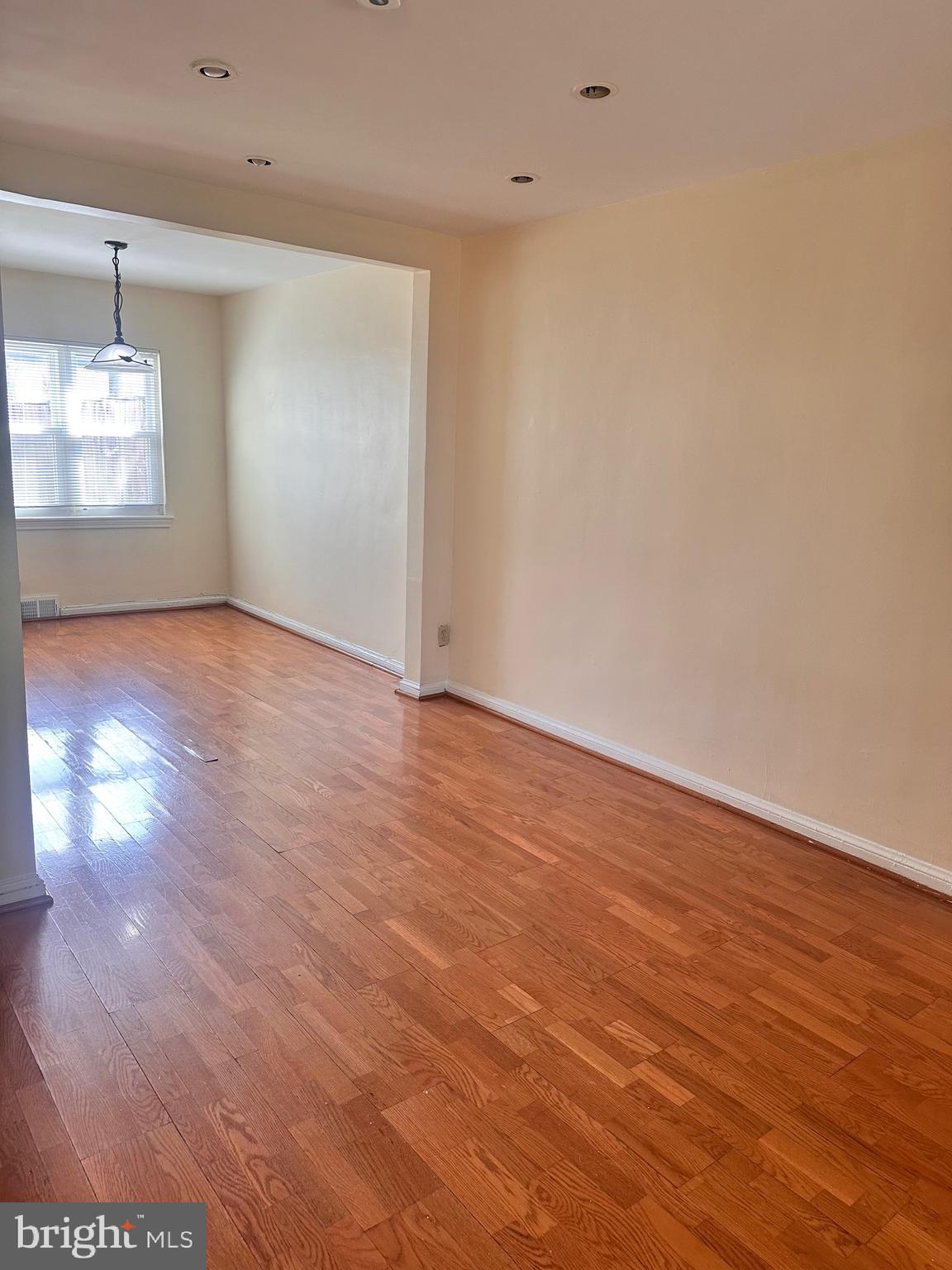 3433 Clay Street Northeast Washington, DC 20019 - Photo 5 of 19 a view of an empty room with window and wooden floor