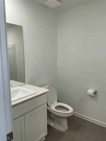 a bathroom with a toilet a sink and mirror
