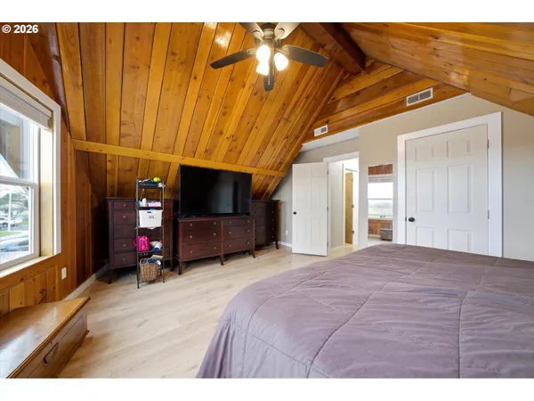 a bedroom with a bed and a flat tv screen