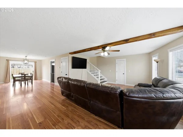 a living room with furniture and a wooden floor