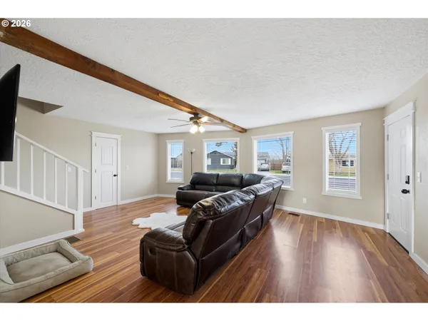 a living room with furniture and a wooden floor