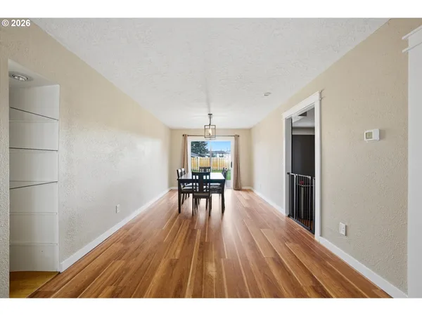 a dining room with furniture and wooden floor