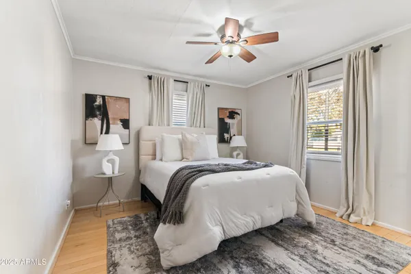 a bedroom with a large bed and a window