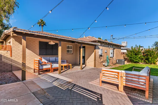 a view of a patio with table and chairs potted plants