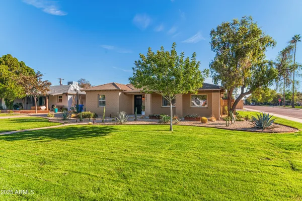 a view of a house with swimming pool and a yard