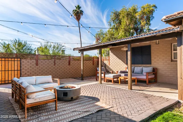 a patio with patio couch and potted plants