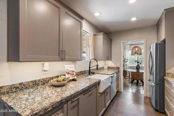 a kitchen with a sink stove and refrigerator