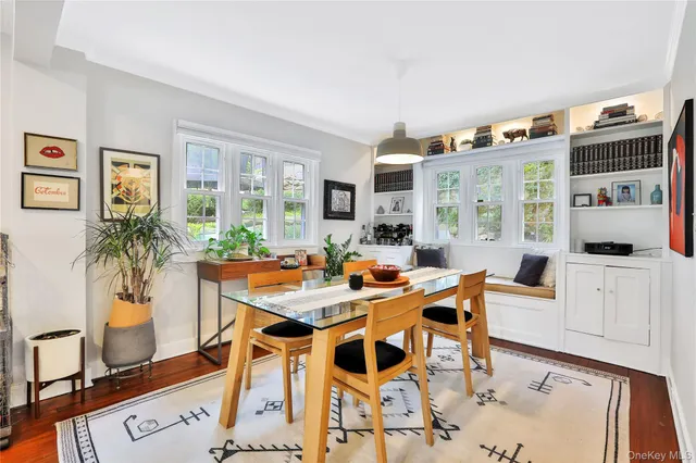 a view of a dining room with furniture and a potted plant