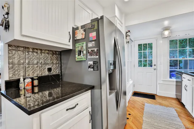 a kitchen with stainless steel appliances granite countertop a refrigerator and a sink