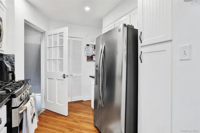 a metallic refrigerator freezer sitting in a kitchen