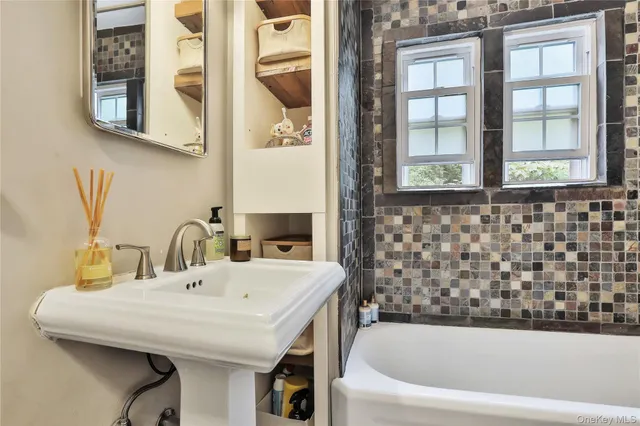 a bathroom with a bathtub and a sink