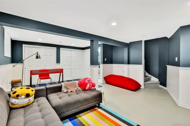 a living room with furniture and gym equipment