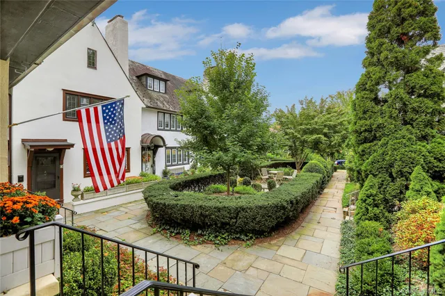 a front view of a house with a garden