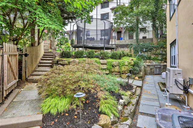 a view of a chair and table in backyard of the house