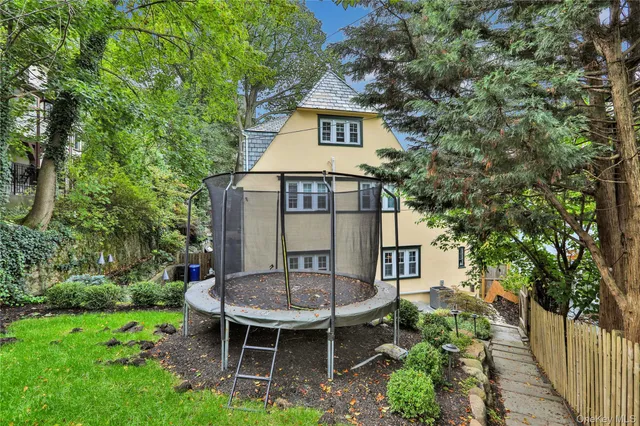 a front view of a house with plants