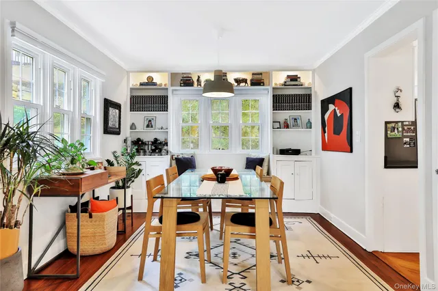 a view of a dining room with furniture and chandelier