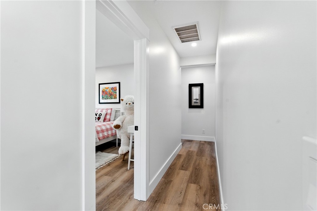 4340 2nd Avenue Los Angeles, CA 90008 - Photo 12 of 51 a view of a hallway with wooden floor and a bathroom