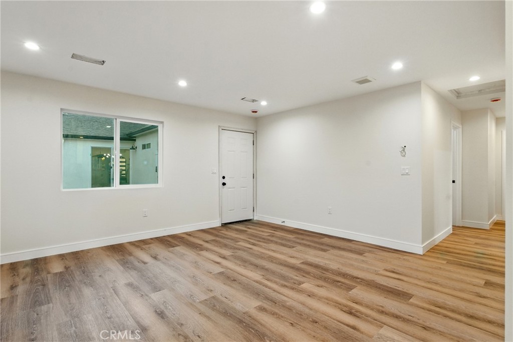4340 2nd Avenue Los Angeles, CA 90008 - Photo 30 of 51 an empty room with wooden floor and windows