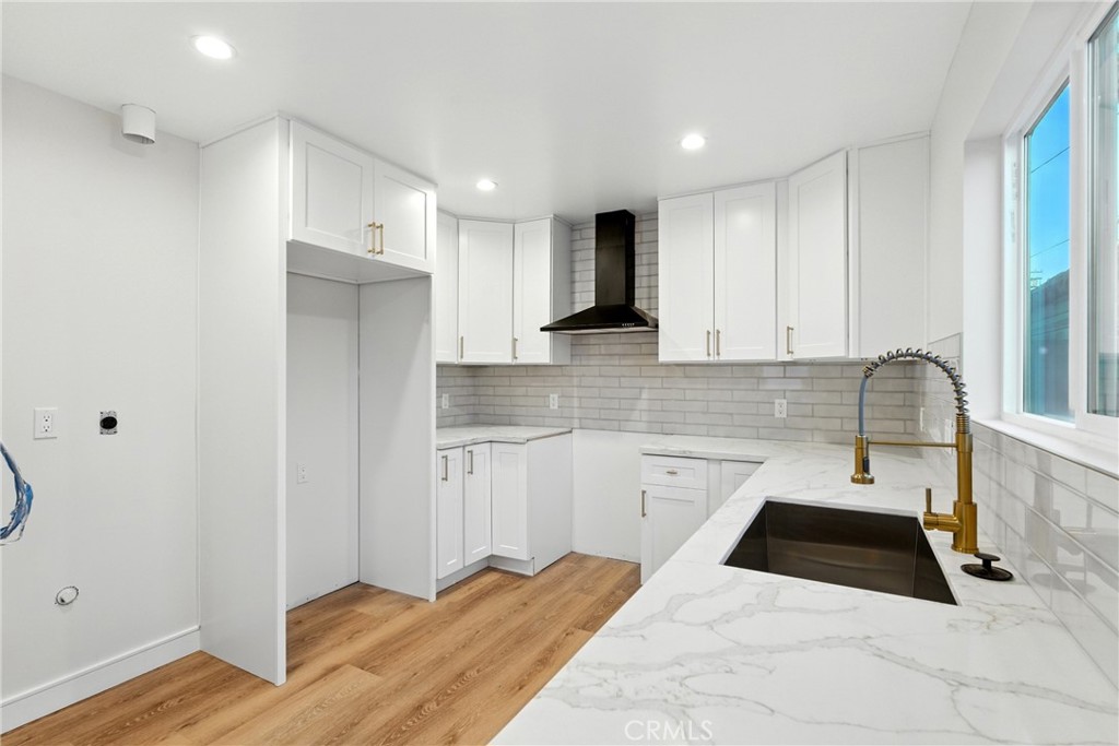 4340 2nd Avenue Los Angeles, CA 90008 - Photo 32 of 51 a kitchen with granite countertop white cabinets and refrigerator