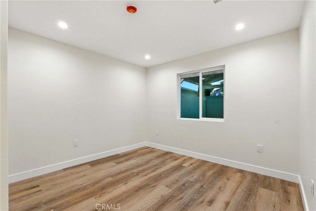 4340 2nd Avenue Los Angeles, CA 90008 - Photo 37 of 51 an empty room with wooden floor and windows
