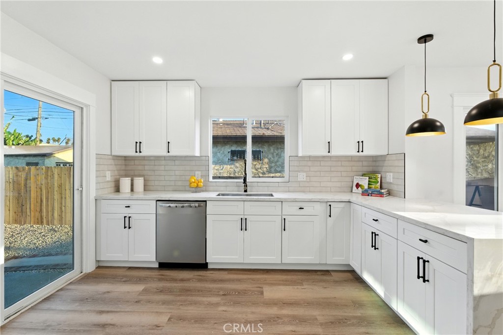 4340 2nd Avenue Los Angeles, CA 90008 - Photo 9 of 51 a kitchen with a sink window and cabinets