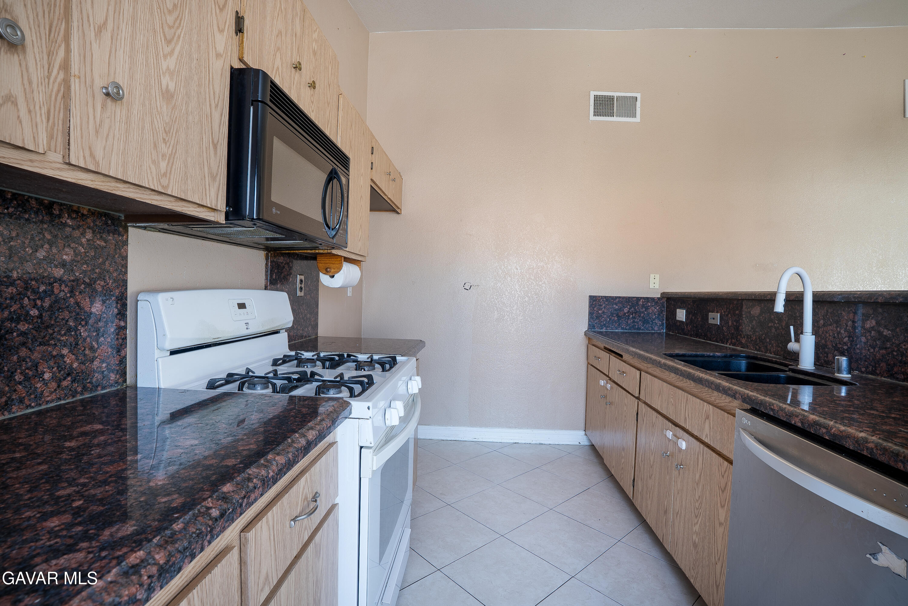 4015 Triton Drive Palmdale, CA 93552 - Photo 5 of 19 a kitchen with stainless steel appliances granite countertop a sink and a stove