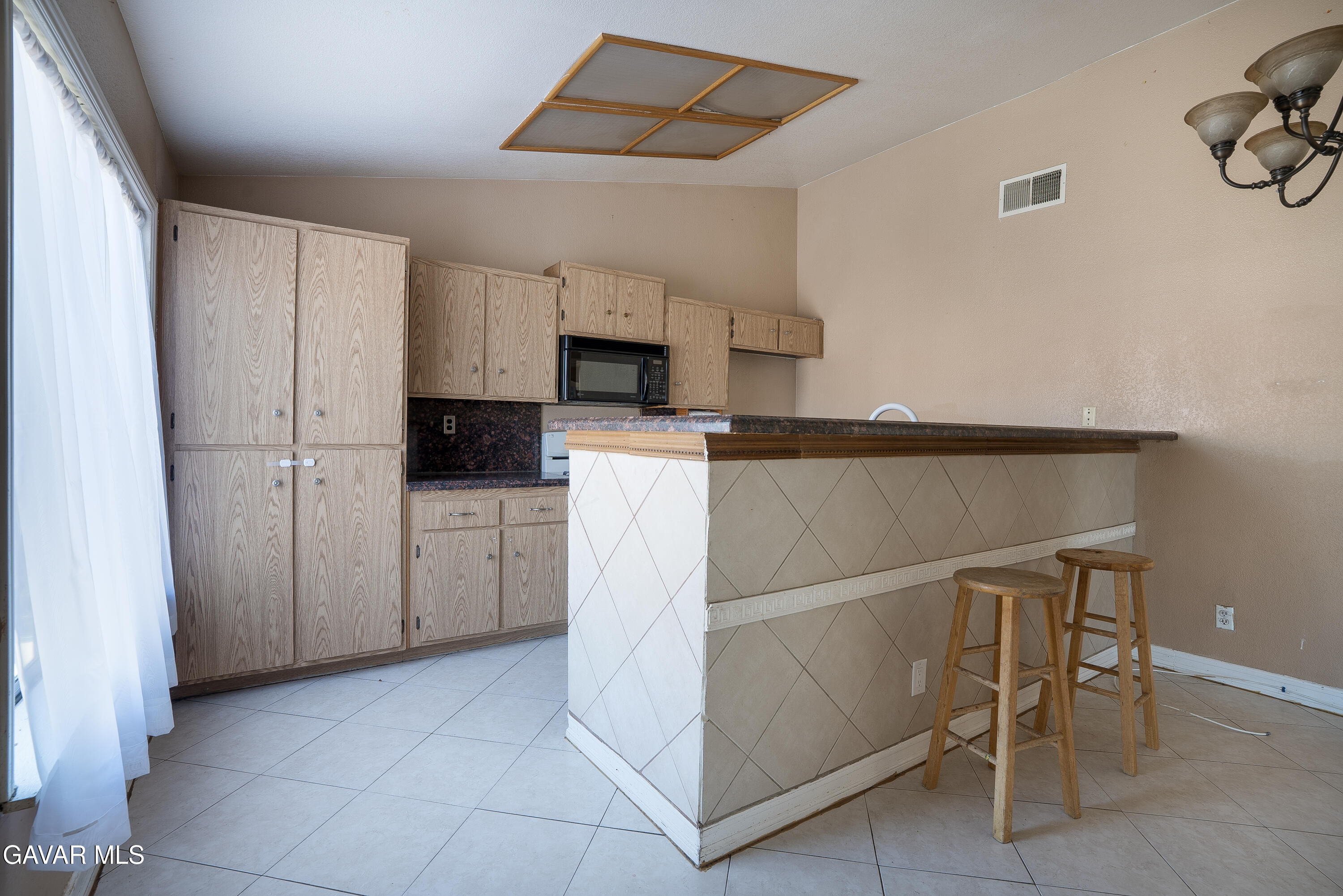 4015 Triton Drive Palmdale, CA 93552 - Photo 6 of 19 a kitchen with white cabinets and refrigerator