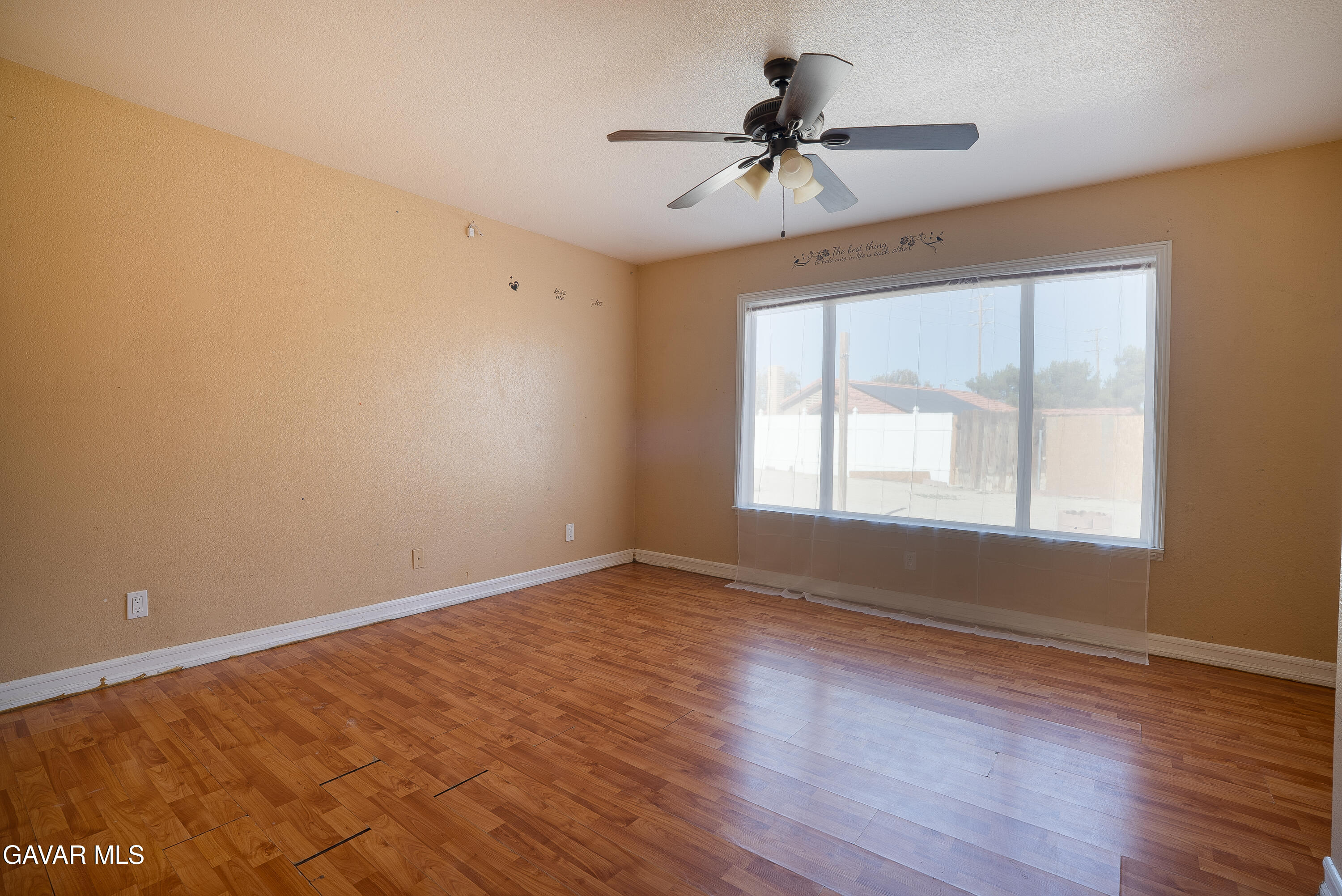 4015 Triton Drive Palmdale, CA 93552 - Photo 8 of 19 a view of an empty room with a window and wooden floor