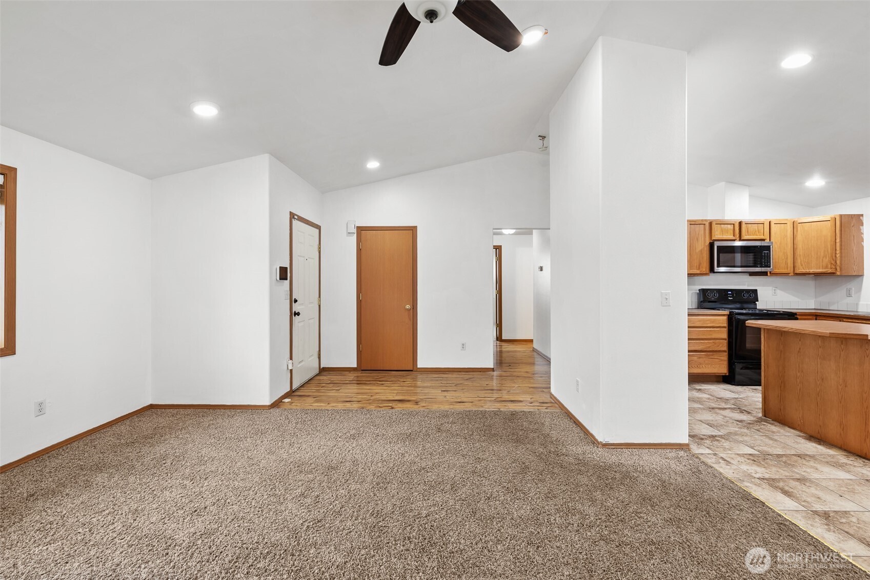980 Capstone Avenue Othello, WA 99344 - Photo 4 of 20 a view of a kitchen with refrigerator and microwave