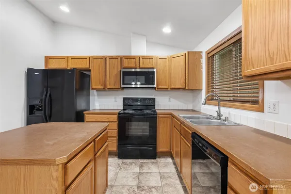 a kitchen with a sink stove and refrigerator