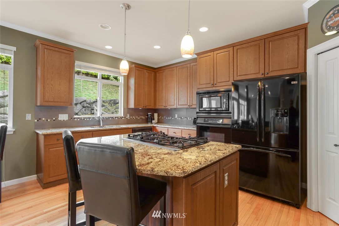 17112 164th Way Southeast Renton, WA 98058 - Photo 14 of 35 a kitchen with a refrigerator a microwave a sink and a stove