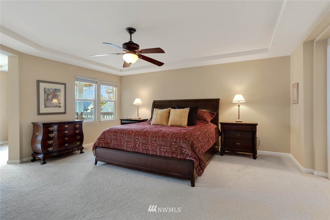 17112 164th Way Southeast Renton, WA 98058 - Photo 21 of 35 a bedroom with a bed and a chandelier