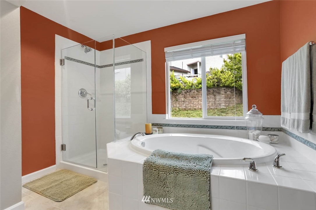 17112 164th Way Southeast Renton, WA 98058 - Photo 25 of 35 a bathroom with a granite countertop sink and a bathtub