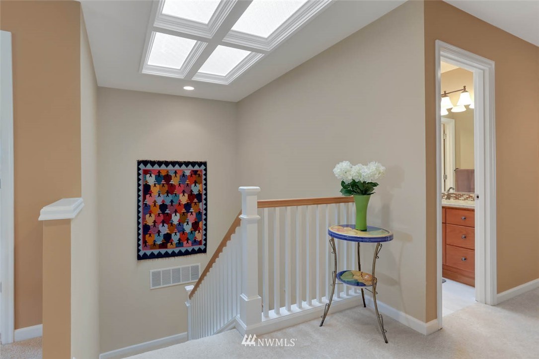 17112 164th Way Southeast Renton, WA 98058 - Photo 27 of 35 a view of a hallway with paintings on the wall